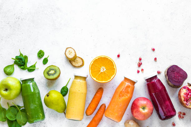 Various smoothies bottles and ingredients Various smoothies or juices in bottles and ingredients on white, healthy diet detox vegan clean food concept, top view, copy space. tropical fruit photos stock pictures, royalty-free photos & images