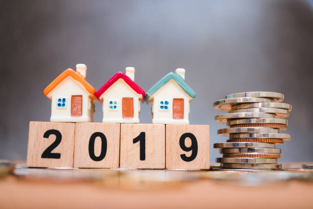 istock Miniature house on wooden block year 2019 1130116972