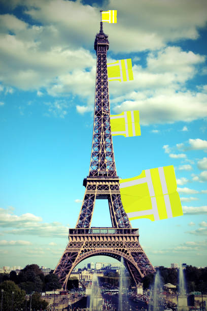 Big flag like a jackets symbol of Yellow vests movement on Eiffe Big flag like a jackets symbol of Yellow vests movement on Eiffel Tower in Paris seen from the Trocadero and old toned effect global populism stock pictures, royalty-free photos & images
