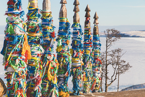 Traditional buryat shaman sacred poles during the winter, cape Burkhan, Olkhon island, Baikal lake Russia