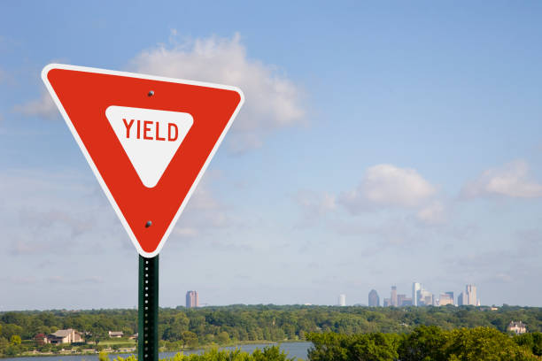istock Yield Sign in Sunshine With A City Skyline 1130119249