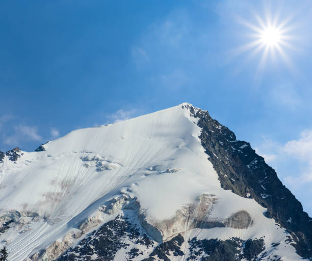 istock mount top in the snow under a sparkle sun 1130119469