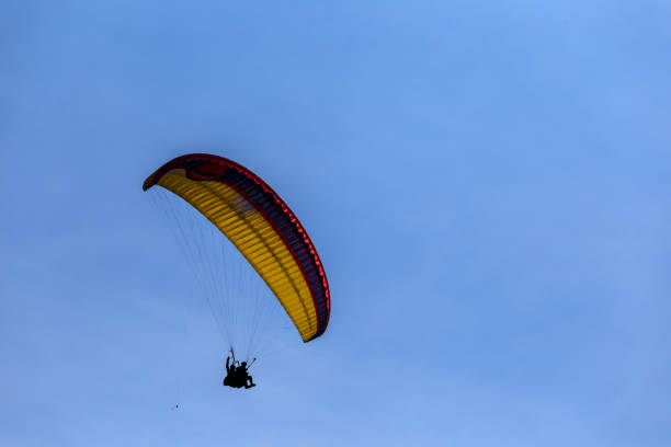 istock closeup paraglider fly in a blue sky 1130119529