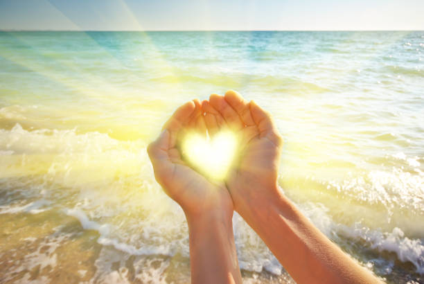 Heart symbol in feminine hand. Conceptual design.