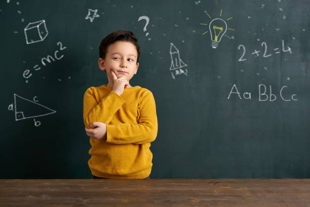 Education 6-7 years old cute child standing front of blackboard 6 7 years stock pictures, royalty-free photos & images
