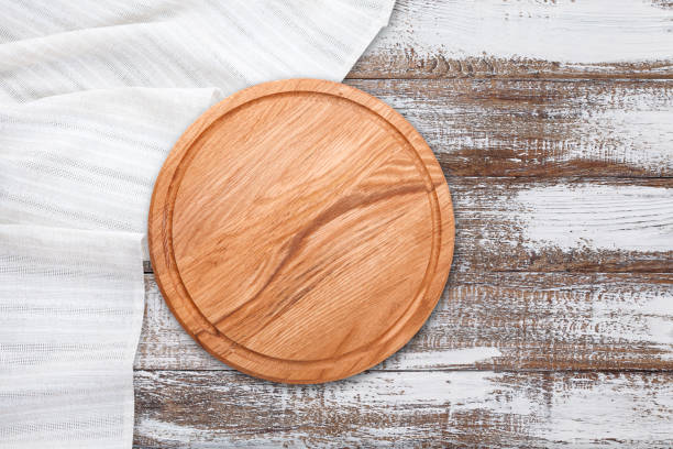 istock Table cloth and pizza board on vintage wooden table. Top view mockup 1130122600