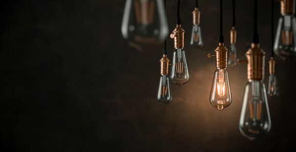 Vintage light bulbs over dark background with copy space