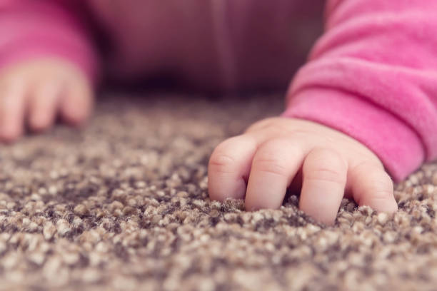 istock Newborn Baby Girl Hand Learning to Crawl 1130124836