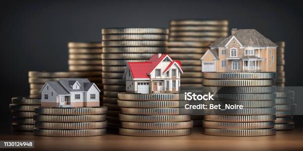 Houses Of Different Size With Different Value On Stacks Of Coins Concept Of Property Mortgage And Real Estate Investment Stock Photo - Download Image Now