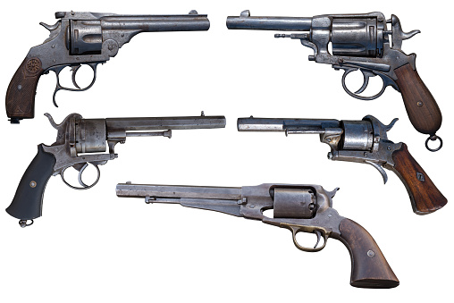 Five antique revolvers isolated on white background..