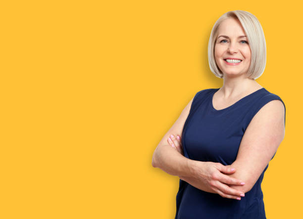 istock Friendly smiling middle-aged business woman isolated on white ba 1130133199
