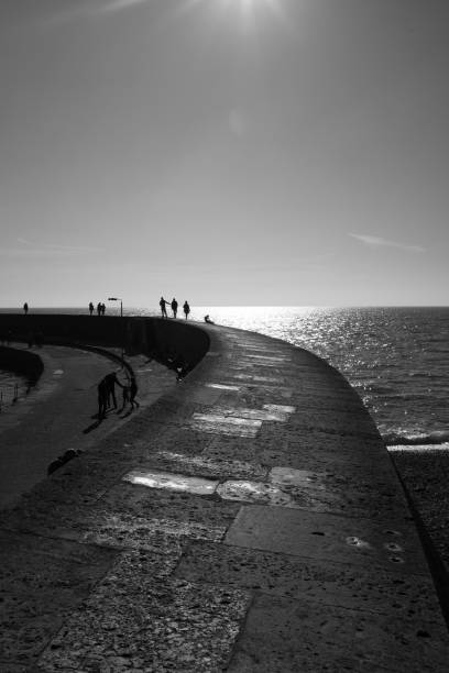 istock Lyme Regis Cob sweeps out to sea 1130133473