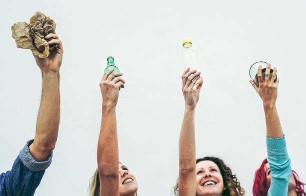 istock Happy people holding recyclable objects as paper, glass, plastic, aluminum on a white background - Eco concept with recycling - Focus on hands 1130134303