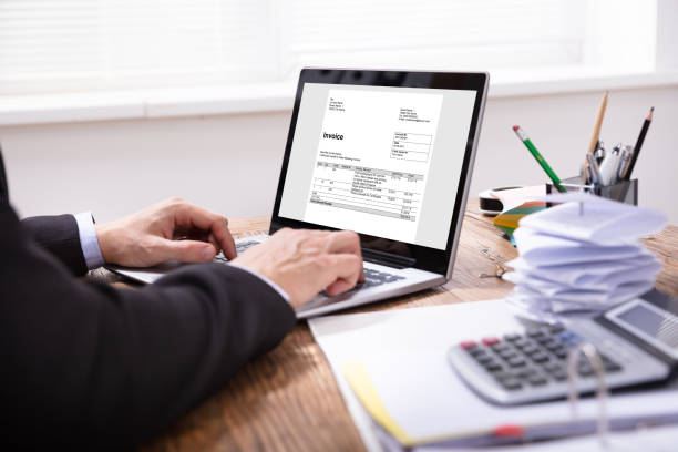 istock Businessman Checking Invoice On Laptop 1130134879