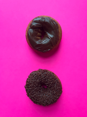 Two donuts on pink background.  iPhone