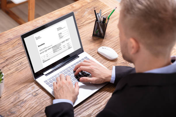 istock Businessman Checking Invoice On Laptop 1130134905