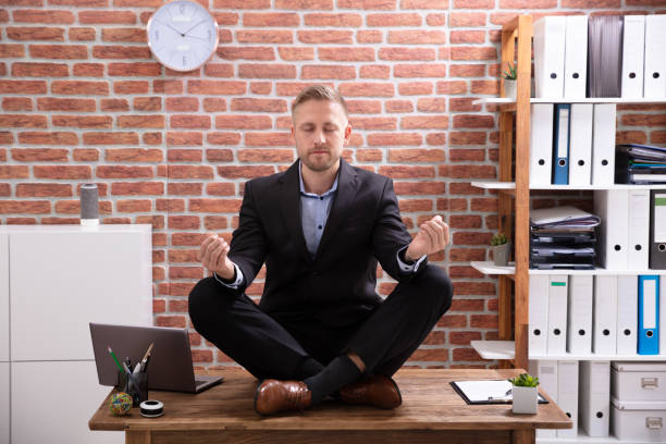 istock Businessman Meditating In Office 1130134936