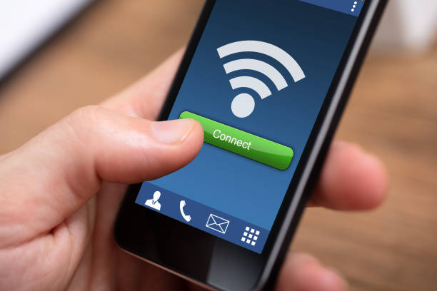 istock Person's Hand Holding Mobile Phone With Wireless Connection 1130134937