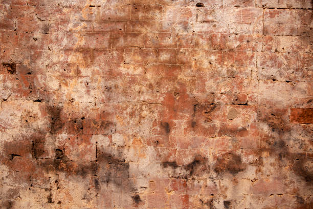 istock Faded brick wall. Orange bricks closeup. Weathered grungy brick wall photo background. Distressed texture of brickwork. 1130136777