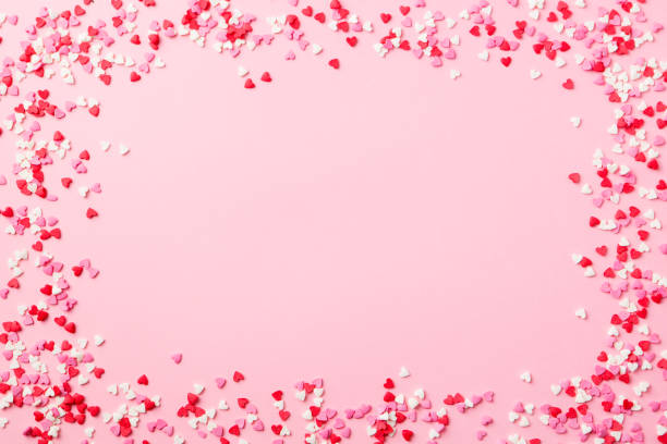 Sugar hearts frame on pink background. Romantic, St Valentines day concept. Top view. Copy space.