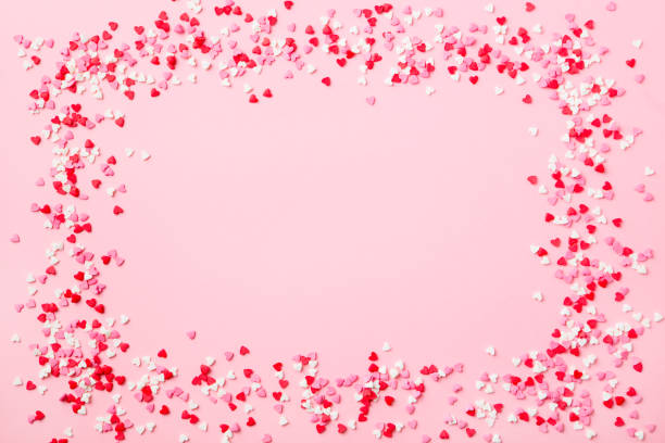 istock Sugar hearts frame on pink background. Romantic, St Valentines day concept. Top view. Copy space. 1130139287