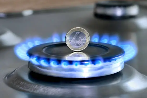 Burning natural gas and one euro coin on gas hob. The concept of the struggle for global gas markets. Turk stream. North stream