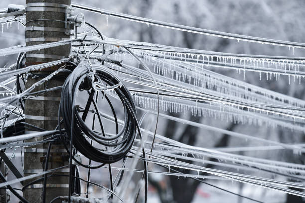 Electricity cables covered in ice after frozen rain phenomenon stock photo