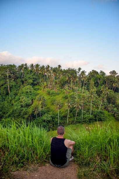 istock Young Man Sitting and Looking at View on Summer Vacations in Indonesia 1130144906