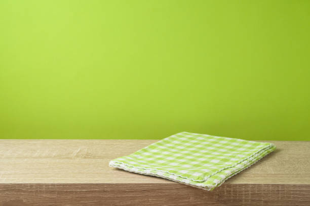 istock Empty wooden table with tablecloth over green wall  background. 1130150677