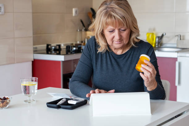 istock Senior  Woman Doing Blood Sugar Test at home 1130152064