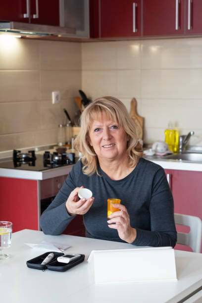 istock Senior  Woman Doing Blood Sugar Test at home 1130152158