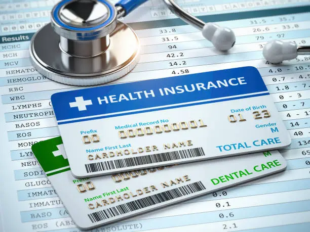 Photo of Health Insurance cards total and dental care with stethscope.