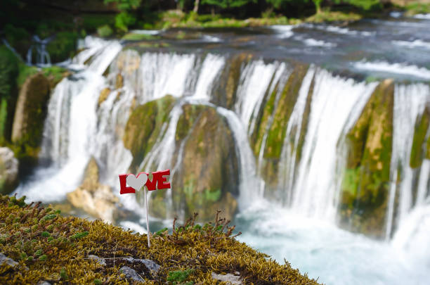 istock love text on a stick above the waterfall 1130163972