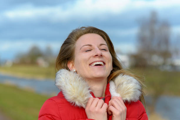 istock Joyful young woman in fur trimmed winter jacket 1130164005