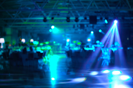blurred background of event concert lighting at conference hall.