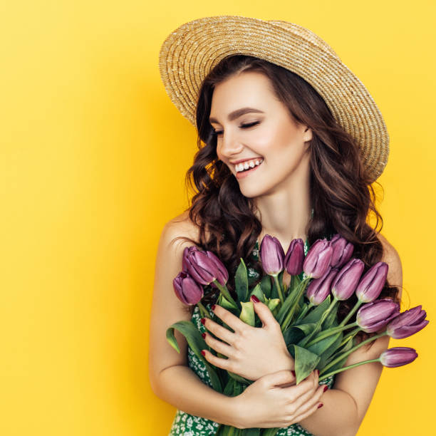 istock Lovely woman with tulips bunch 1130165356