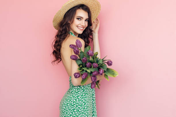istock Lovely woman with tulips bunch 1130165381