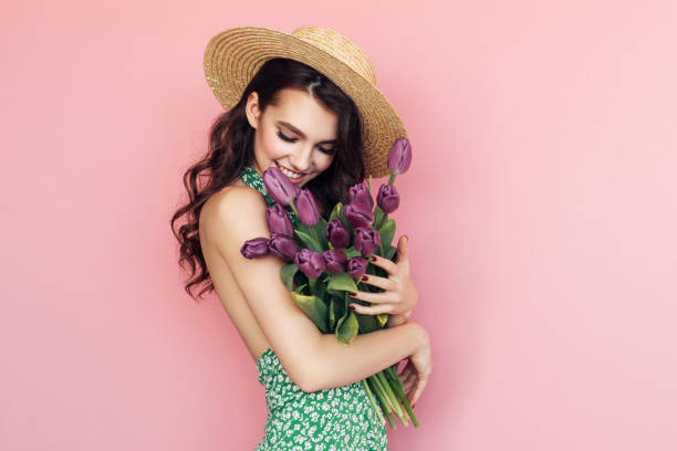 istock Lovely woman with tulips bunch 1130165424