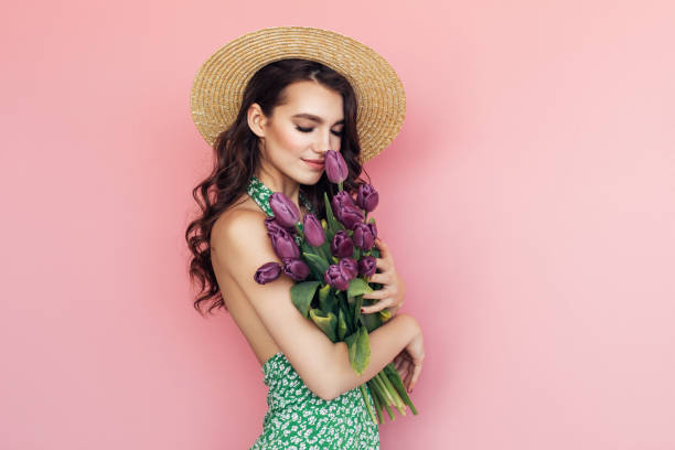 istock Lovely woman with tulips bunch 1130165447
