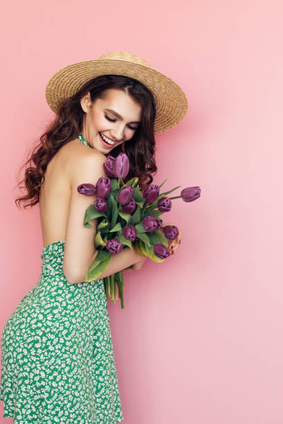 istock Lovely woman with tulips bunch 1130165506