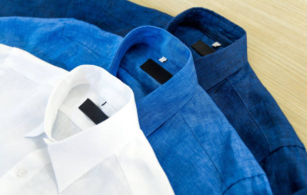 istock Three men's shirts in white, blue and dark blue color 1130179553