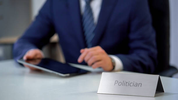 istock Male politician elaborating bill for business lobbying, working on tablet pc 1130184155