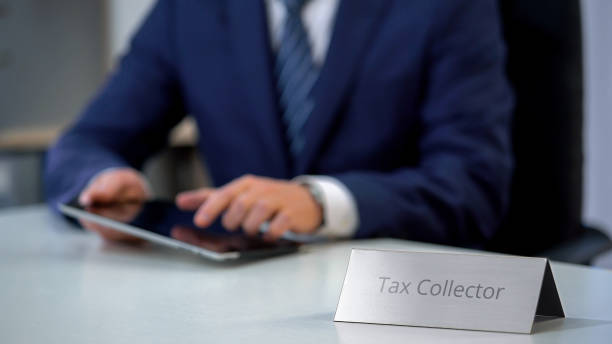 istock Tax collector using tablet pc with database of debtors with bad credit history 1130184348