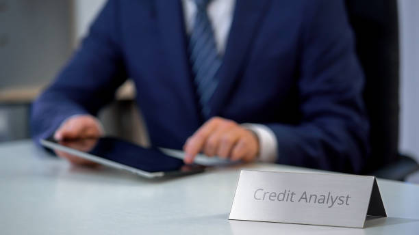 istock Busy credit analyst working on tablet pc, checking financial report online, work 1130184563