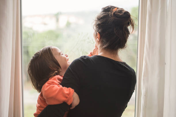 istock Mother and son looking out of window 1130186644