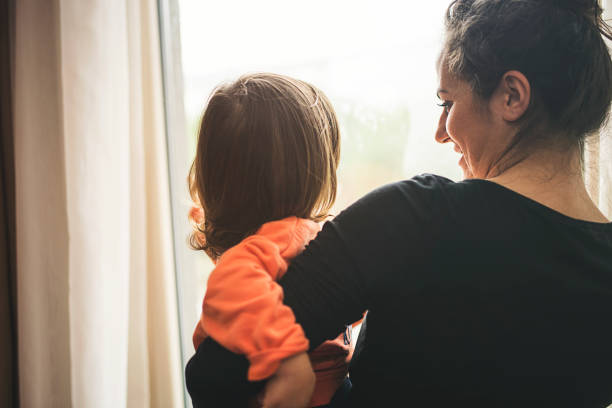 istock Mother and son looking out of window 1130186652