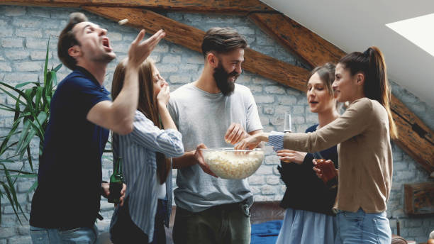 istock Girl feeding her friend with popcorn 1130187636
