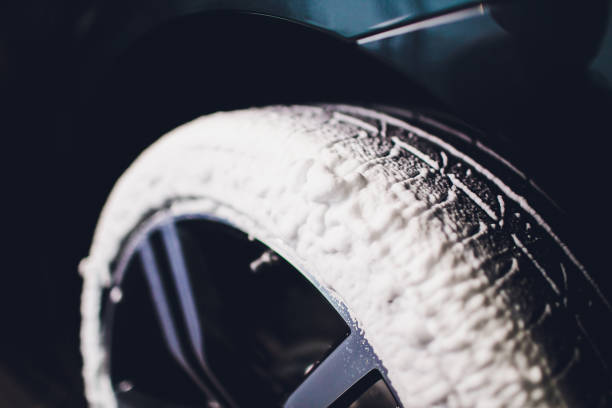 istock Car Care or Car Detailing Process. Using black sponge to washing the tire. blacker rubber. 1130187911
