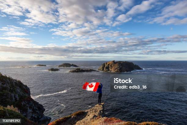 Woman By The Ocean Cliff Stock Photo - Download Image Now - Canada, Canadian Flag, Landscape - Scenery