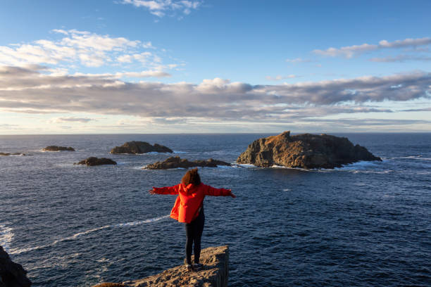 istock Woman by the ocean cliff 1130189394